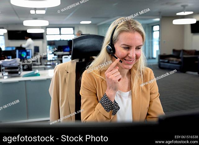 Businesswoman using headset at modern office