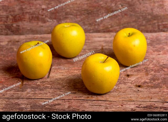 yellow apples on a old wooden table, studio picture