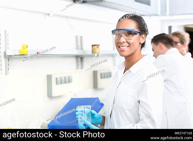 Female lab technician with safety goggles in laboratory