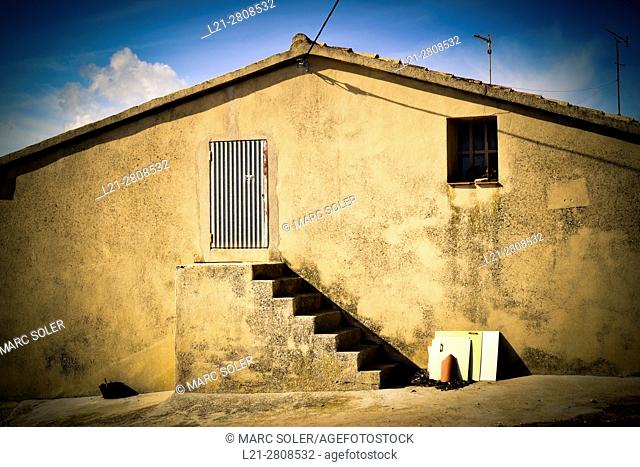 Stairs to a closed door in a catalan typical farmhouse called 'masia'. Barcelona province, Catalonia, Spain