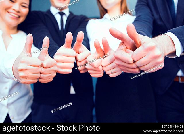 Business People Making Thumbs Up After Having Successful Meeting In Office. Business Concept