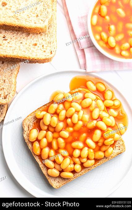 Toast bread with baked beans on plate. Top view