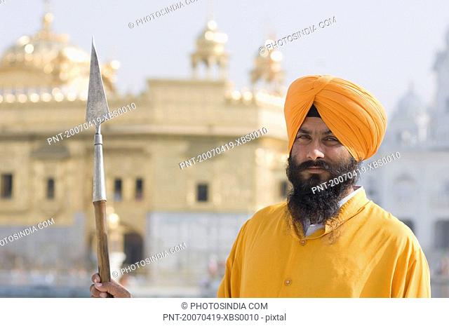 Portrait of a Sikh guard holding a spear, Golden Temple, Amritsar, Punjab, India