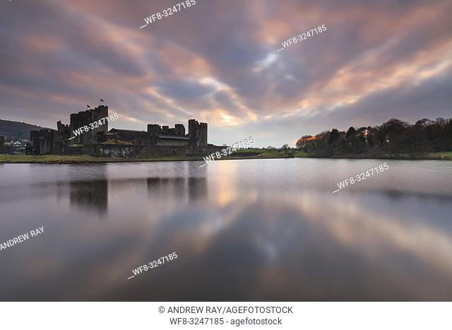 Sunset over Caerphilly Castle in South Wales, captured on an evening in mid February. A long shutter speed was utilised to flatten ripples on the surface of the...