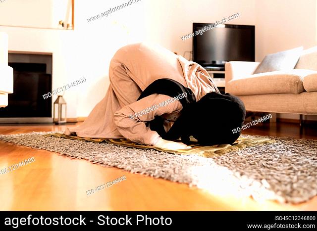 Muslim woman praying, in sujud position