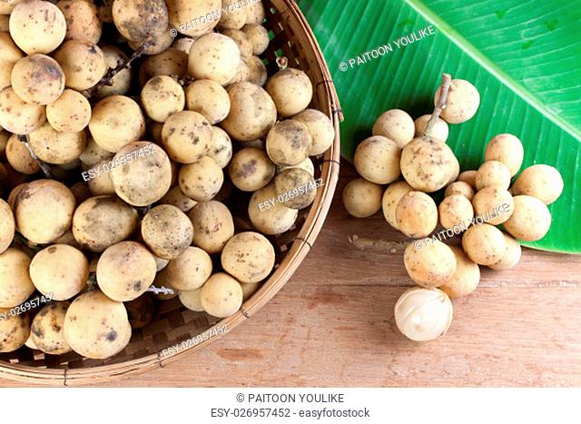 Longkong, Langsat or Lanzones fruit piled in a basket on wood table