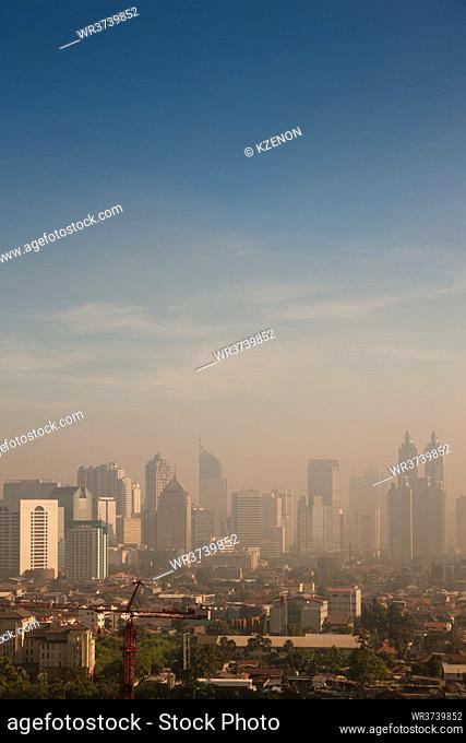 Smog dome and dust during sunrise in a very polluted city - in this case Jakarta, Indonesia