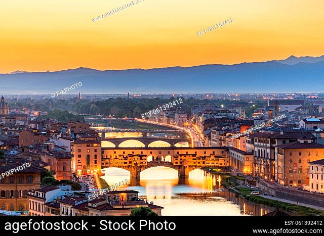View of Florence at sunset with the Ponte Vecchio bridge over the Arno River