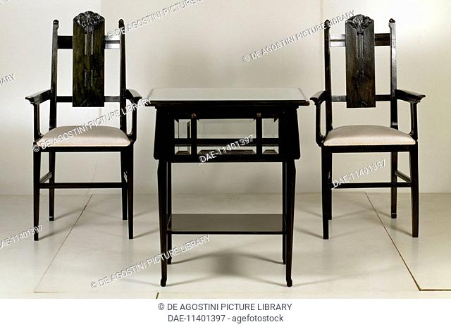 Table with two armchairs, 1906, by Giacomo Cometti (1863-1938), green aniline-dyed wood. Italy, 20th century.  Milano, Archivio C.Venturini