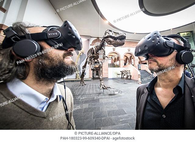 23 March 2018, Germany, Frankfurt am Main: Museum director Bernd Herkner (R) and project manager Philipe Havlik (L) wear virtual reality glasses at the...