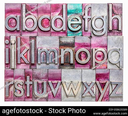 lowercase English alphabet in vintage, gritty metal letterpress type stained by printing inks, rectangular composition isolated on white