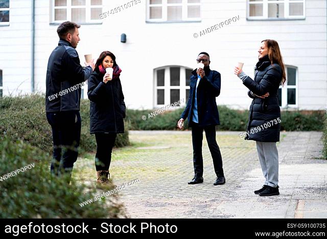 Social Distancing Employees Outside Drinking Coffee During Break