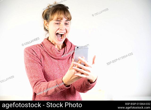 Extremely joyful woman at the sight of her new smartphone