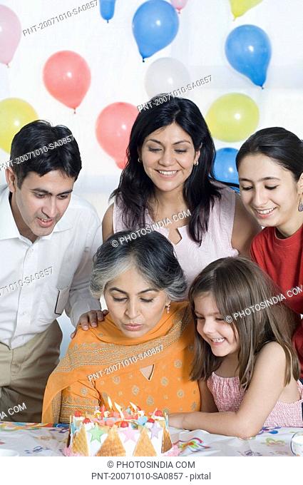 Mature woman celebrating her birthday with her family