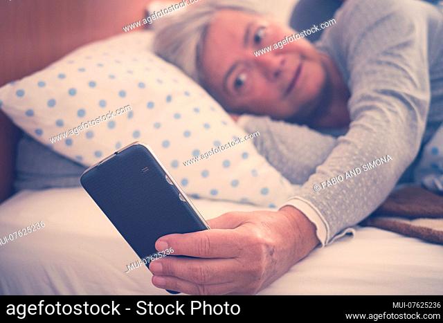 nice beautiful couple enjoy the morning and check the alarm on the phone. app help to wake up and start the day and the usual life