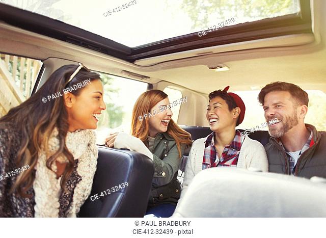 Couples riding and laughing in car