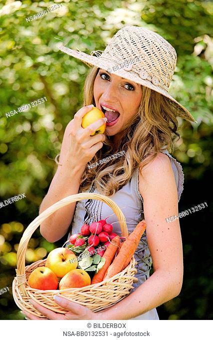 Fruit and vegetables in the basket with woman