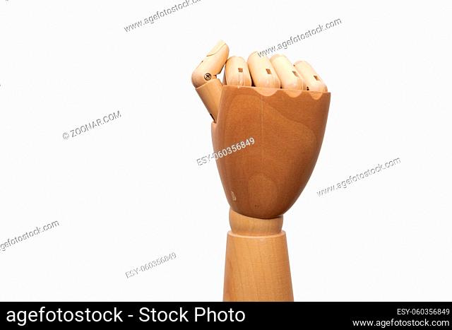 Right hand of wooden dummy mannequin clenching fingers to fist on white background