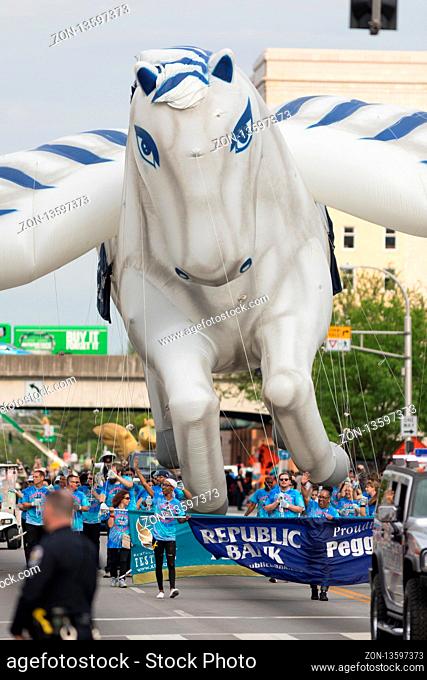 Louisville, Kentucky, USA - May 03, 2018: The Pegasus Parade, Large balloon in shape of a pegasus carried by people down W Broadway