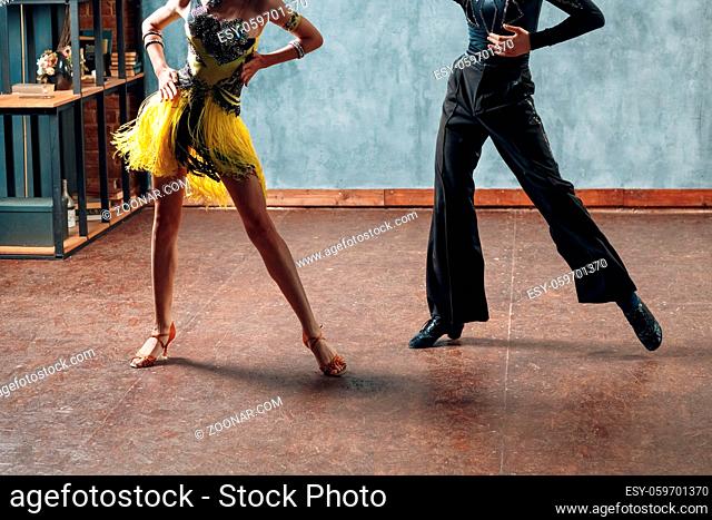 Ballroom dancing. Young couple ballroom dancers. Legs in rumba dance
