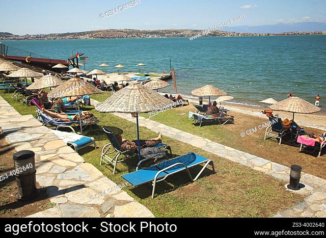 People sunbathing at the beach of ancient Kydonies todays Ayvalik town, Balikesir, Aegean Region, Turkey, Europe