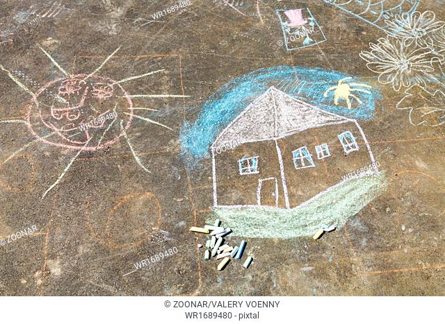 child drawing - house and sun painted on asphalt