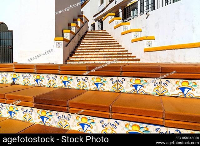 Arcos de la Frontera, Spain - 27 January, 2021: Spanish architecture style buildings with whitewashed walls and beautiful colorful tiled stairs