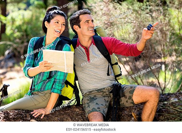 couple smiling and holding map and compass