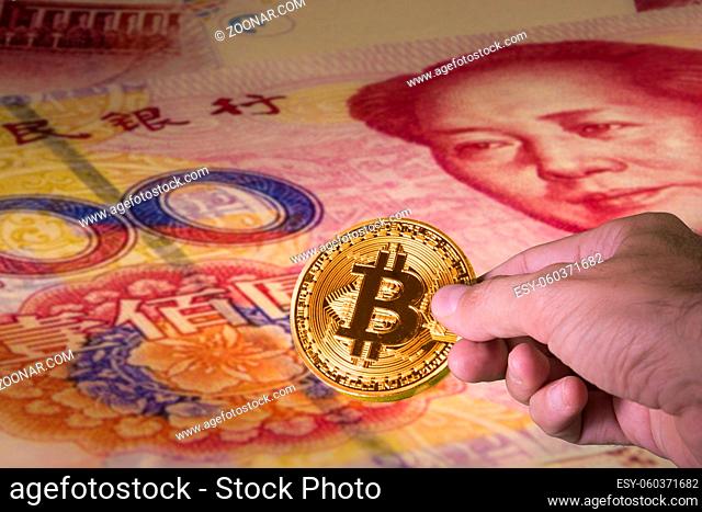 Financial concept with golden Bitcoin on 100 yuan or renminbi banknote, Chinese Currencies