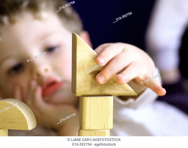 Boy concentrating on building blocks