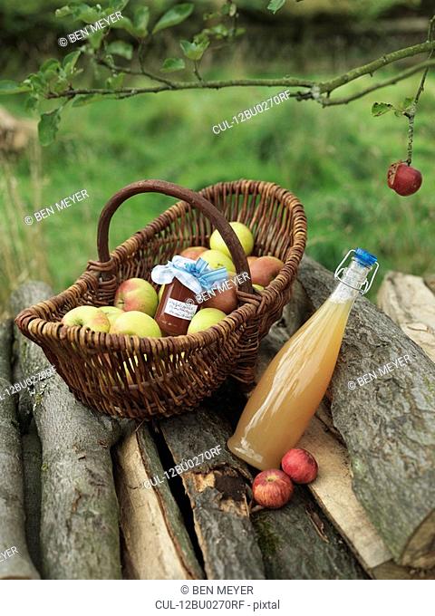 Apples in basket with jar and juice