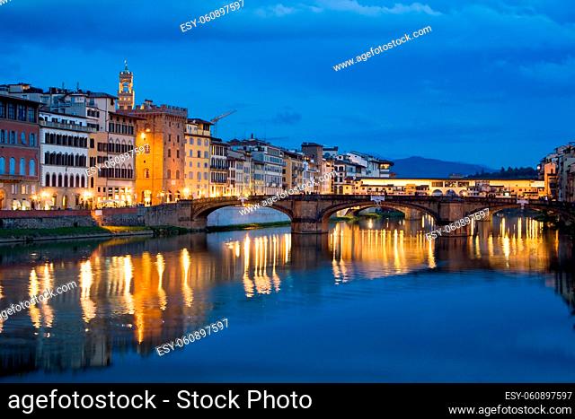Ancient buildings and old bridge reflecting in River Arno in Florence, Italy