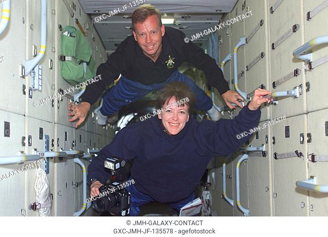 STS-104 crewmembers Steven W. Lindsey, mission commander, and Janet L. Kavandi, mission specialist, travel through the Zarya module during their visit to the...