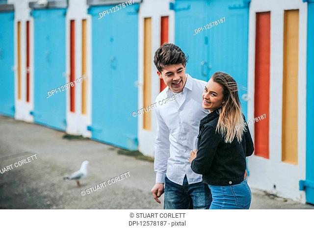 Young man and young woman smiling and laughing together; Wellington, North Island, New Zealand