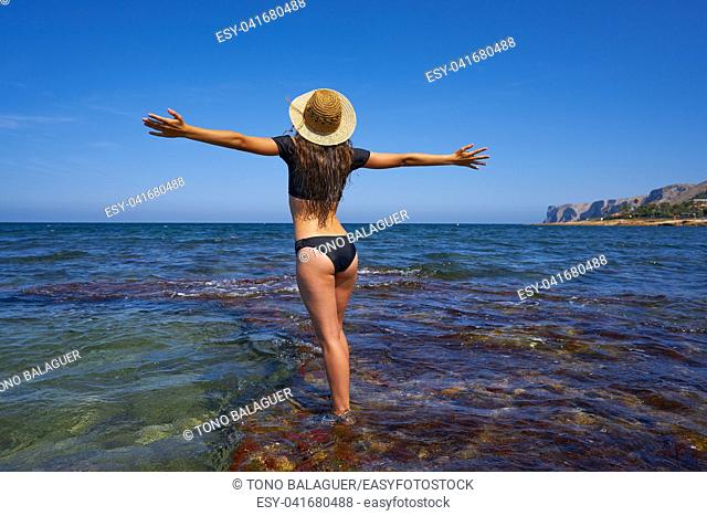 Bikini girl in summer Mediterranean beach having fun open arms excited