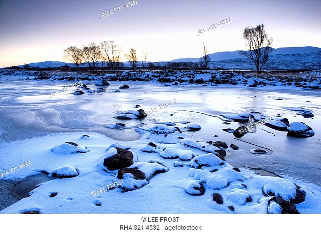 Dawn view of frozen Loch Ba on snow-covered Rannoch Moor, Highland, Scotland, United Kingdom, Europe
