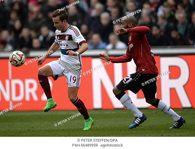 Hanover's Jimmy Briand (R) and Munich's Mario Goetze vie for the ball during the German Bundesliga soccer match between Hannover 96 and FC Bayern Munich at HDI...