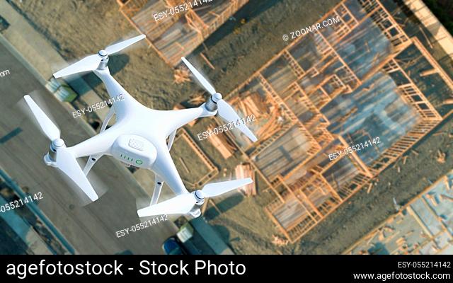 Unmanned Aircraft System (UAV) Quadcopter Drone In The Air Over Construction Site