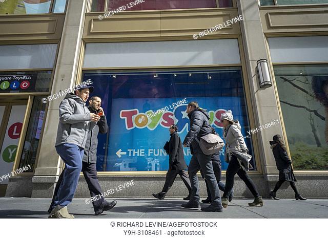 Passerby outside the Toys R Us store in Times Square in New York on Friday, March 16, 2018. Toys R Us is liquidating and closing all 735 of its U. S