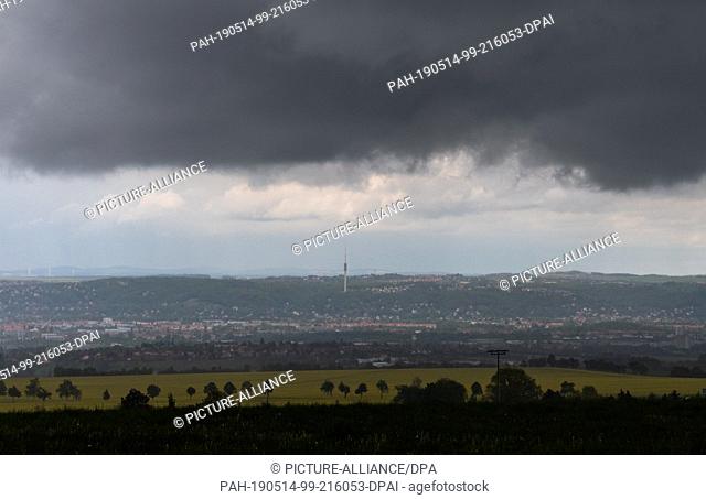 14 May 2019, Saxony, Dresden: Rain clouds are streaming across the Elbe valley with the Dresden television tower. Photo: Robert Michael/dpa-Zentralbild/dpa