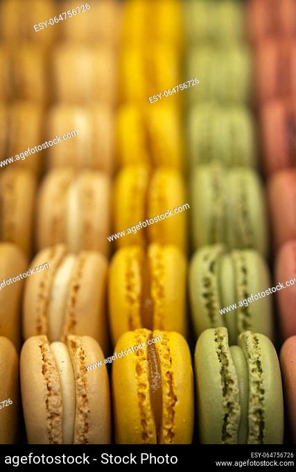 macaroons of different colors on a black background