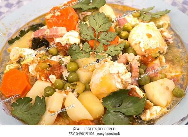 Traditional portuguese culinary meal of green peas with egg, potatoes and carrots