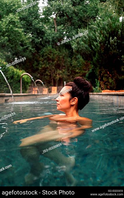Woman in swimming pool in spa resort