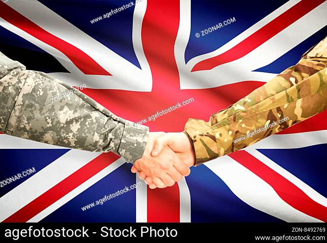 Soldiers shaking hands with flag on background - United Kingdom