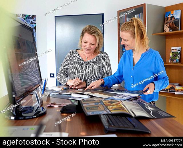 Two colleagues discuss new advertising material