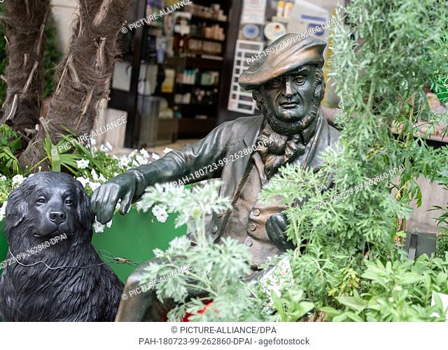 20 July 2018, Germany, Bayreuth: A sculpture of Richard Wagner is nestled among some greenery in the inner city. This year's Bayreuth Festival is due to start...