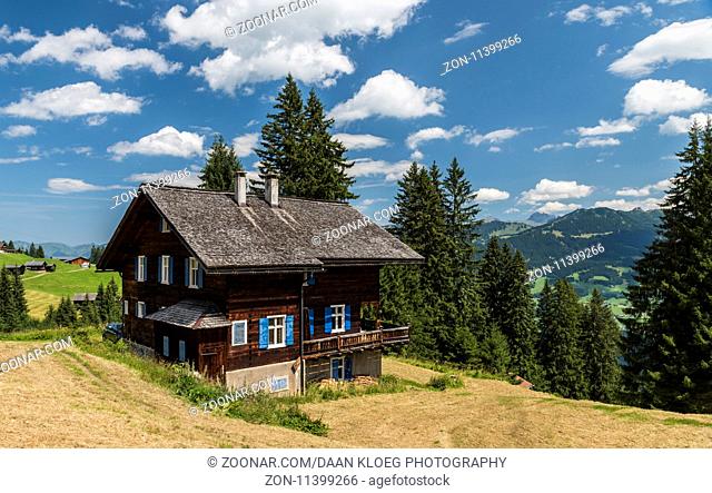Matschwitz, Austria - July 21, 2017: Old wooden cabin in Matschwitz with in the background the mountains of Montafon on a summers day, Austria