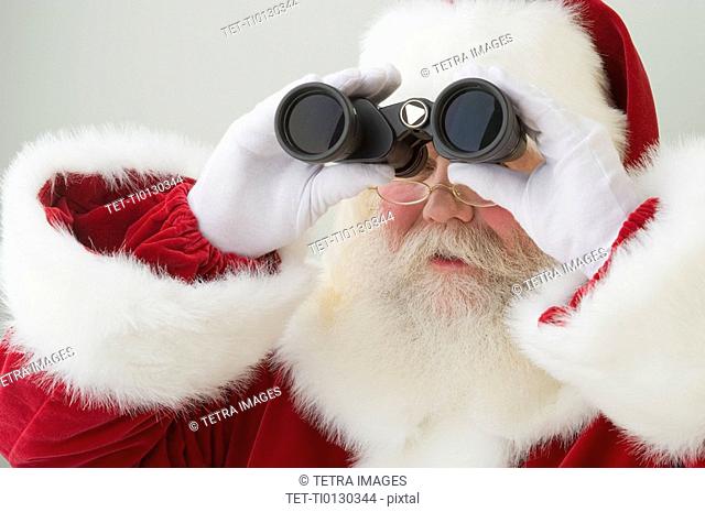 Santa Claus looking through binoculars