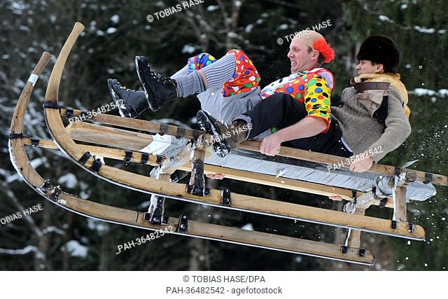 Two people race horn sleds during the traditional Schnablerrennen sled race in Gaissach, Germany, 27 January 2013. Over 100 costumed sled racers took part in...