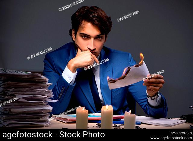 Businessman burning the evidence late in office